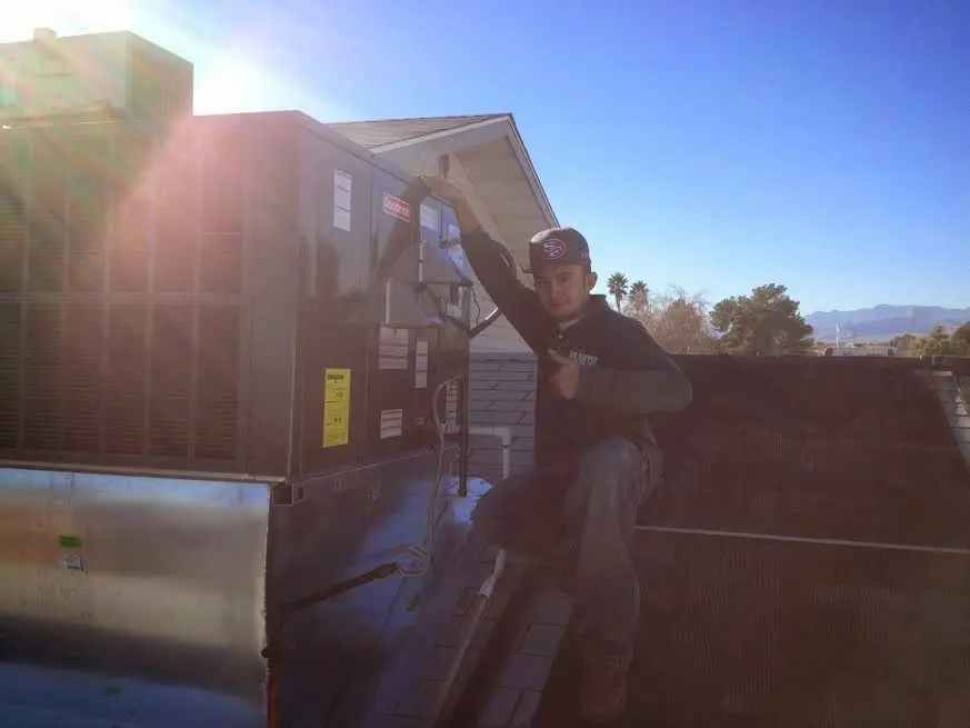 HVAC technician performing HVAC Inspection on a rooftop unit in Meraux